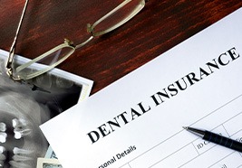 A dental insurance form on a wooden desk