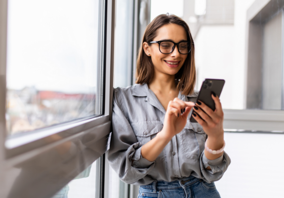Woman with glasses looking at her phone
