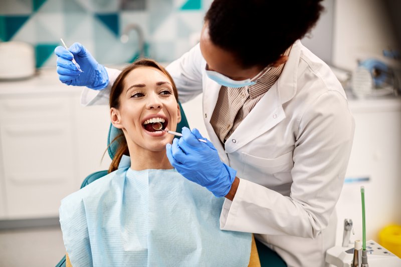 A beautiful woman receiving a dental checkup from her dentist